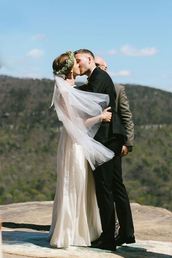 bride and groom first kiss