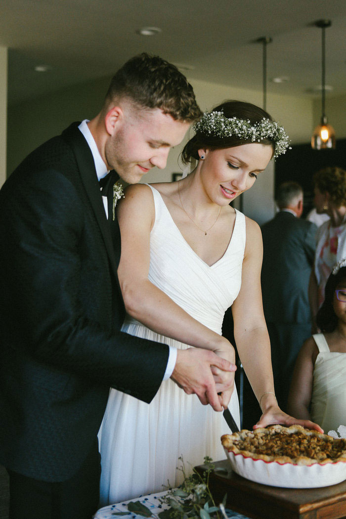 bride and groom cutting pie