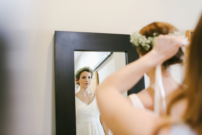 bride putting on baby's breath crown