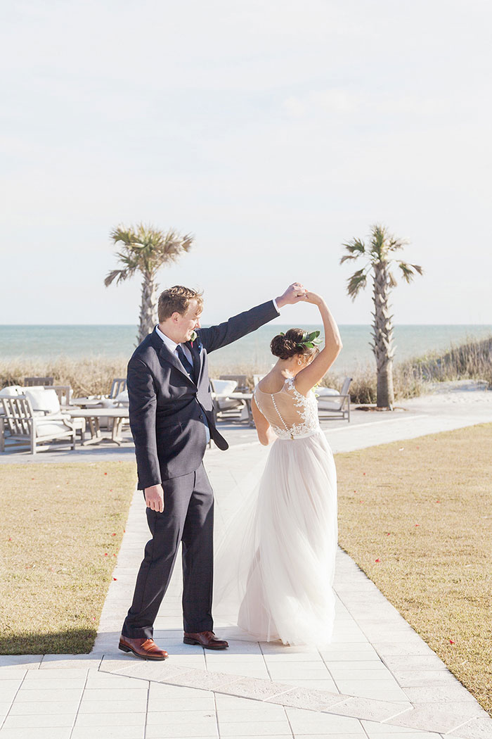 bride and groom dancing on boardwalk