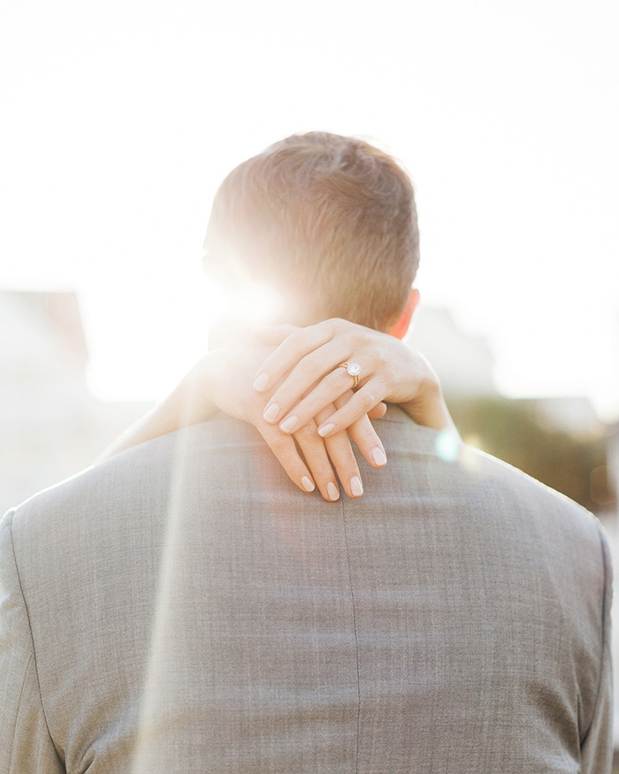 bride's arms around groom's neck