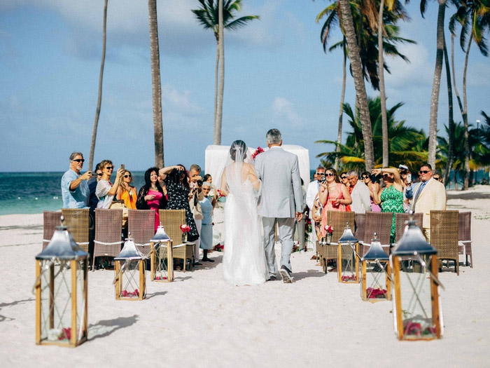 bride walking down aisle on the beach