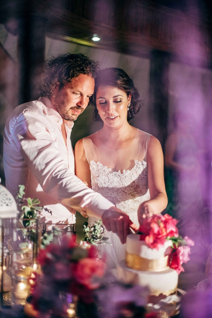 bride and groom cutting cake