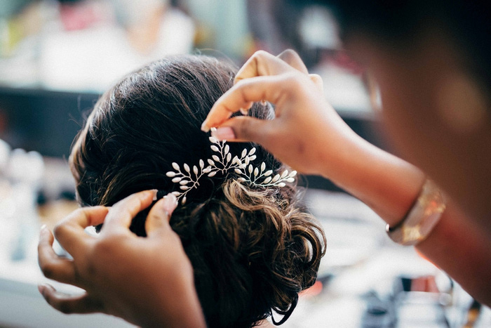 jeweled comb being placed in bride's hair