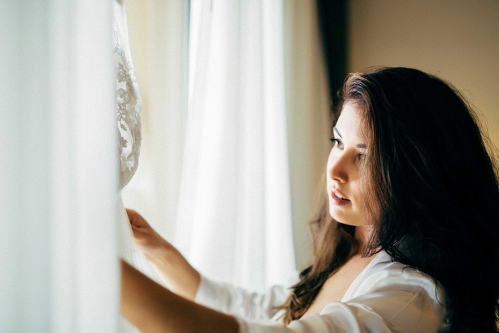 bride looking at wedding dress