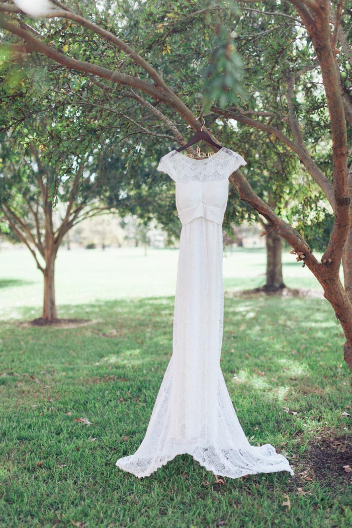 wedding dress hanging on tree