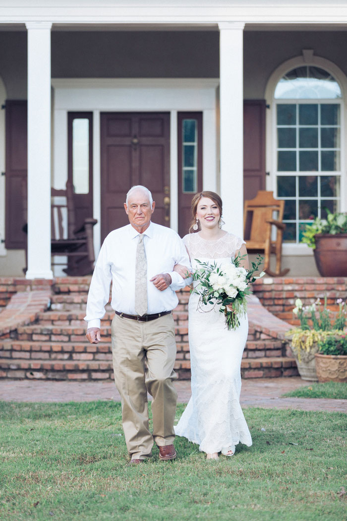 bride walking down aisle with father