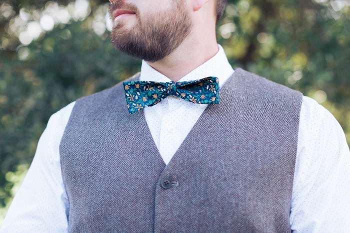 groom wearing floral bow tie