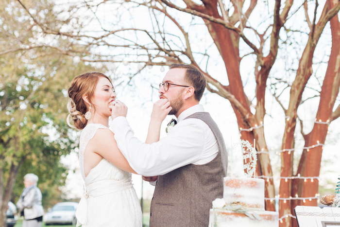 bride and groom feeding each other cake