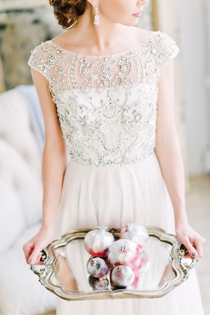 bride holding tray of pomegranates