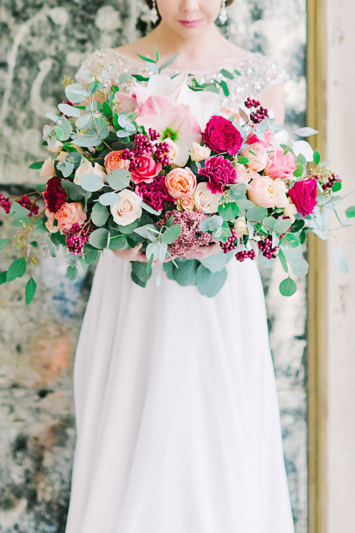 bride holding large bouquet of flowers