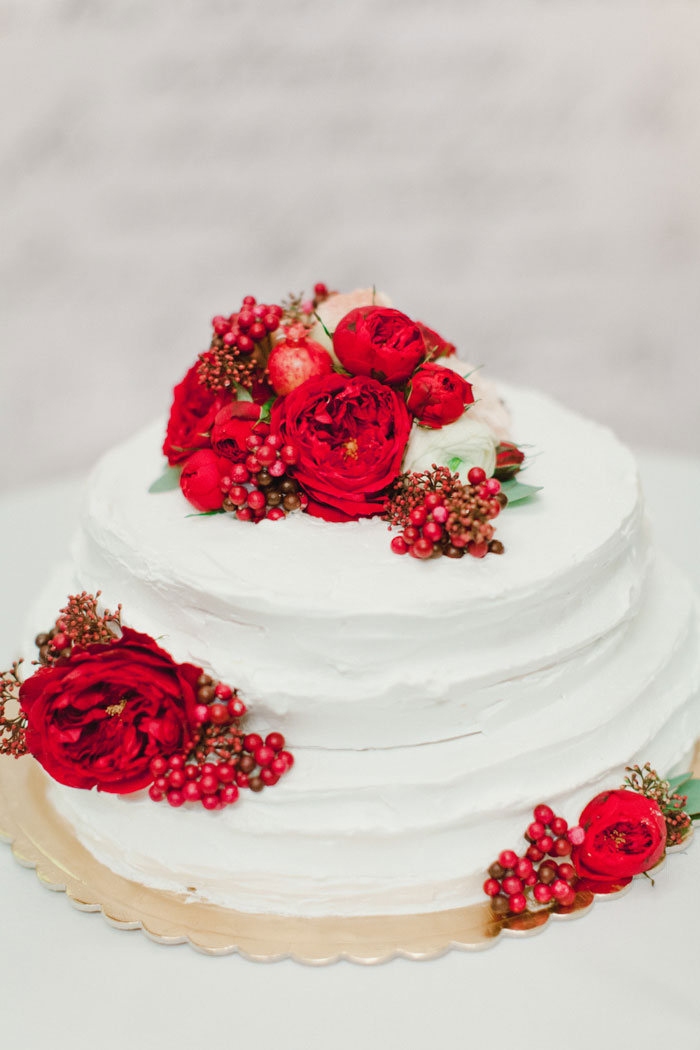 white wedding cake with red flowers