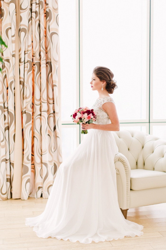 portrait of bride sitting on chair arm