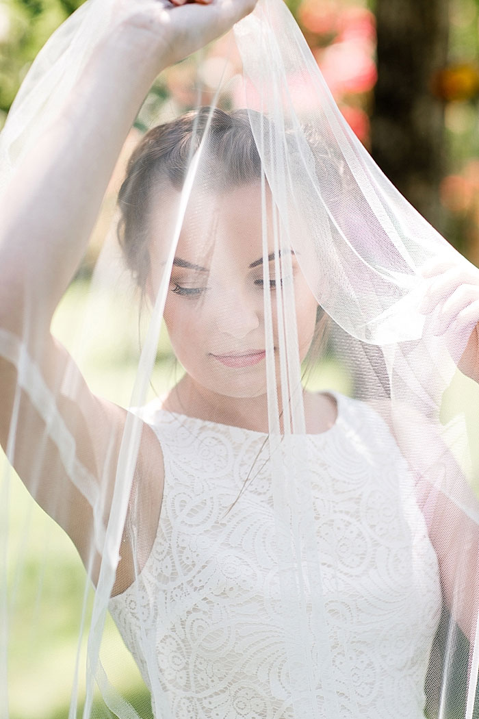 bride holding up veil