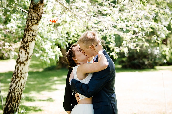 bride and groom first kiss