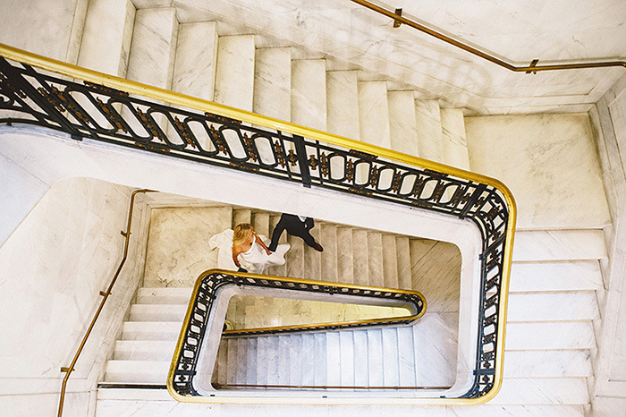 bird's eye view of bride and groom going down stairs