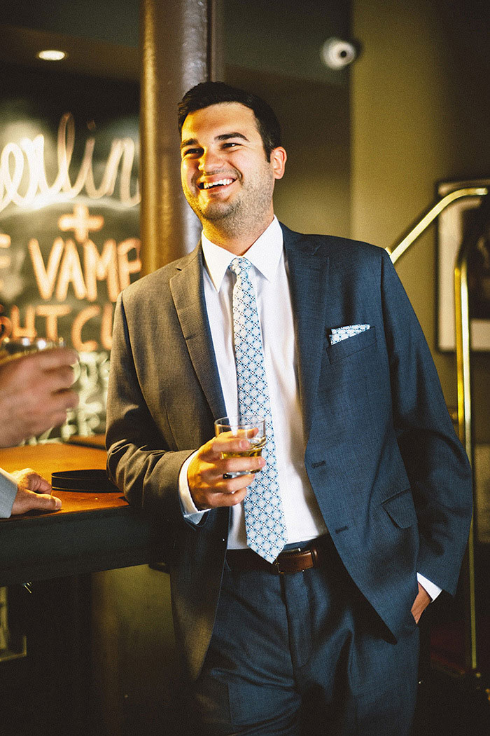 groom with glass of whiskey