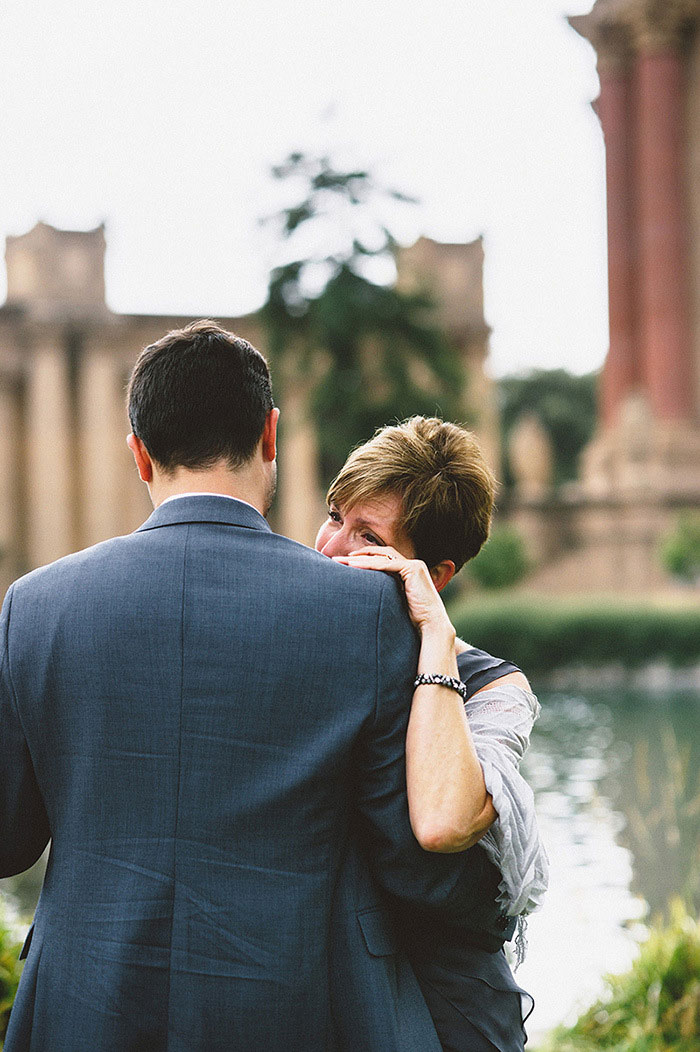 groom and mother dancing in the park