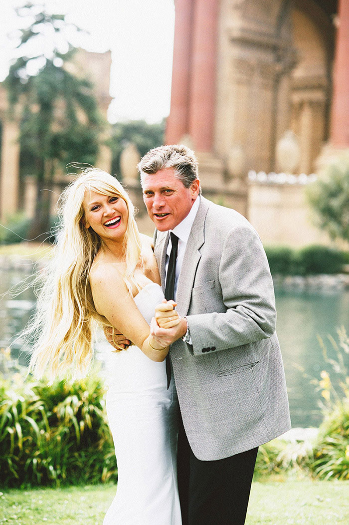 bride and father dancing in the park