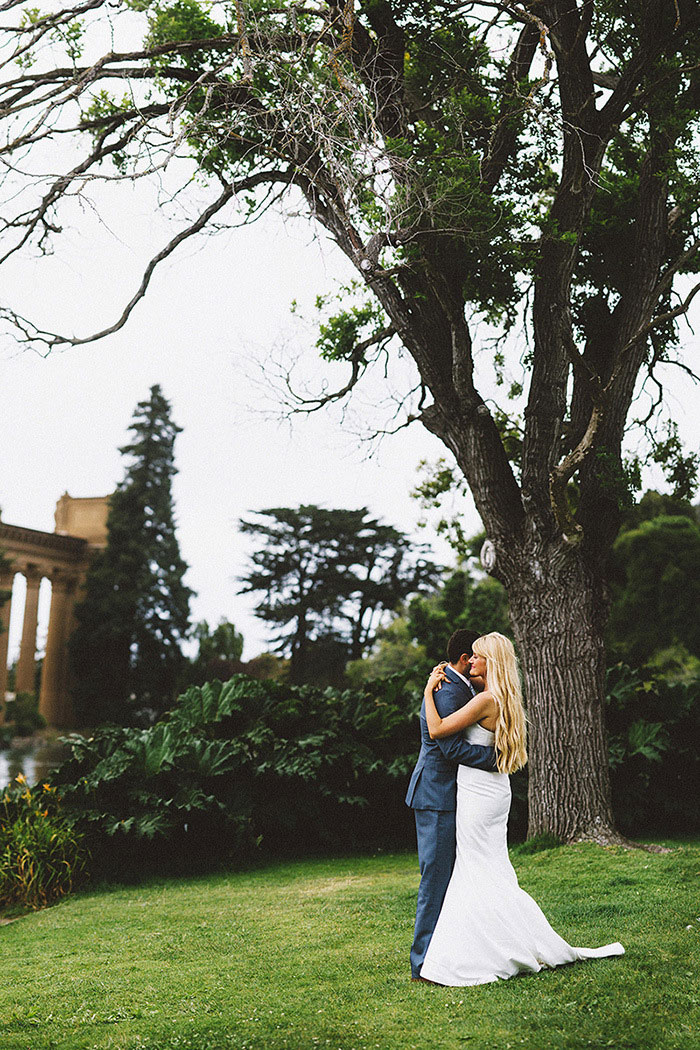 bride and groom dancing in the park