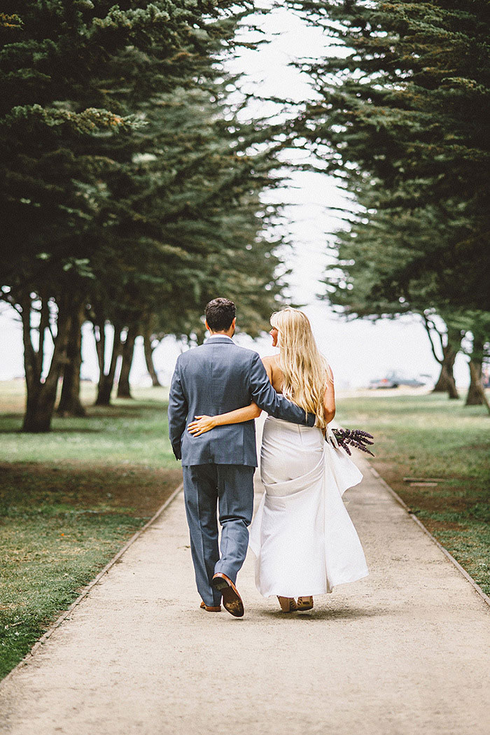 bride and groom portrait walking away