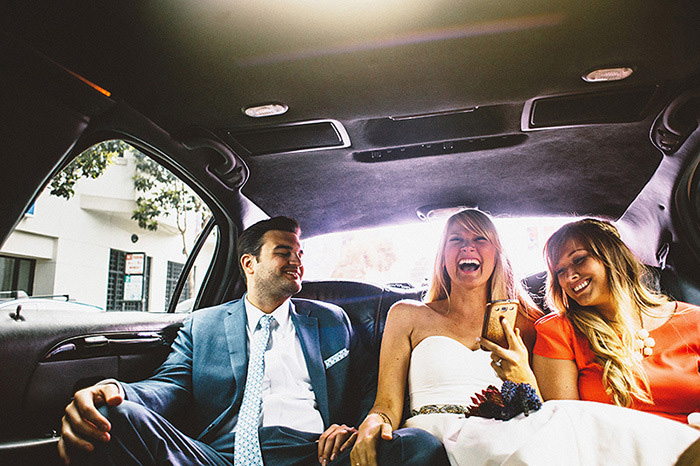 bride and groom in back of car