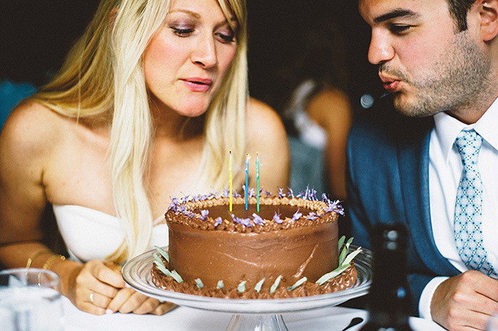 bride and groom blowing out candles