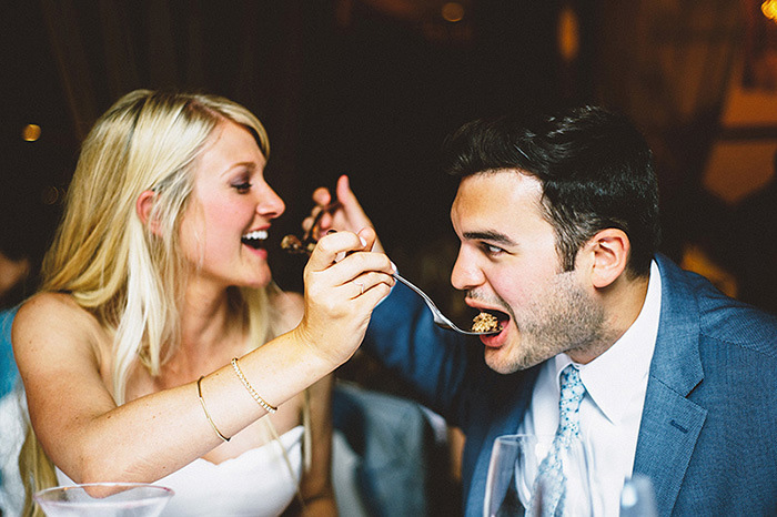 bride and groom feeding each other cake