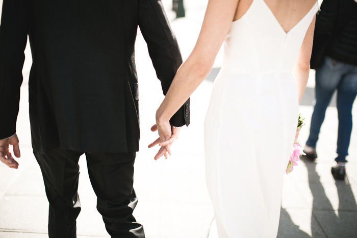 bride and groom holding hands