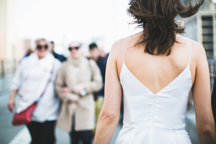 back of bride walking on street