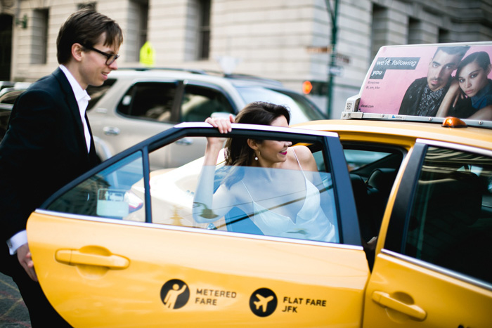 bride getting into yellow taxi