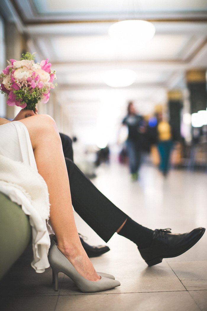 bride and groom's legs while waiting at city hall