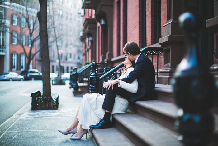 bride and groom kissing on stoop