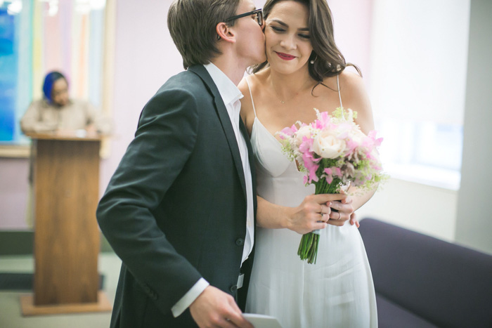 groom kissing bride at city hall elopement