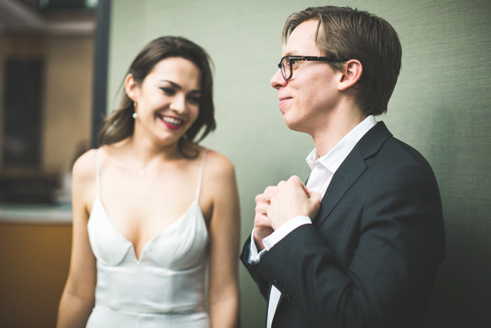 groom adjusting tie