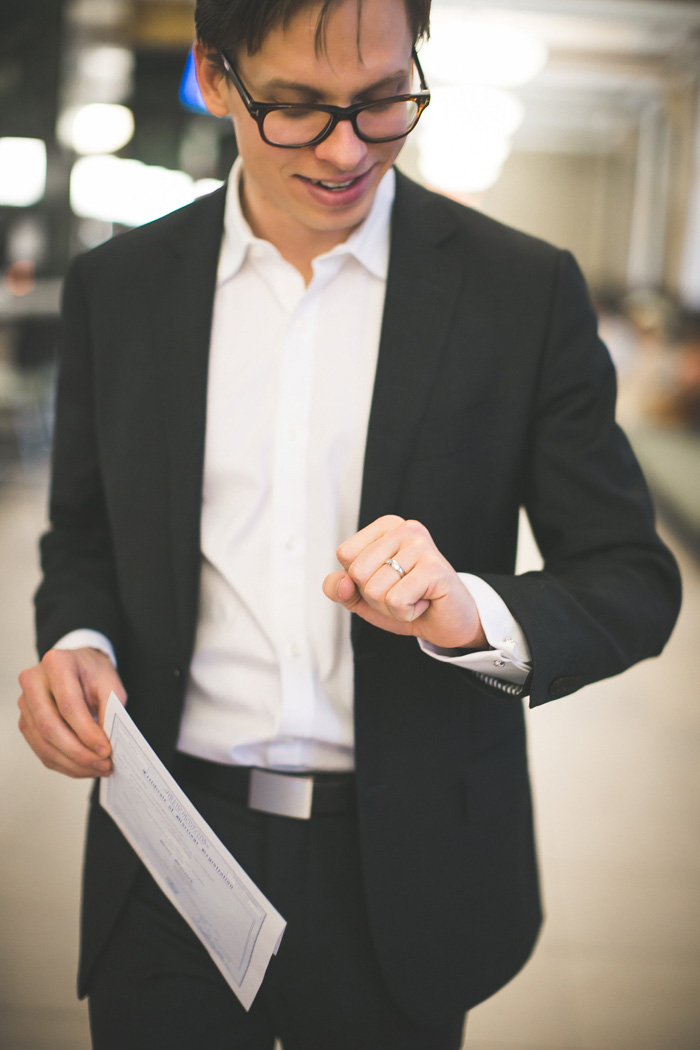 groom looking at ring on his finger