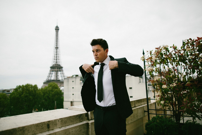 groom putting on jacket