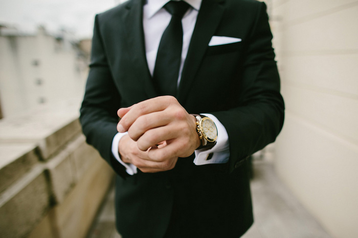 groom putting on watch