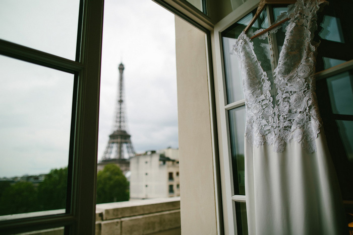 wedding dress hanging on door