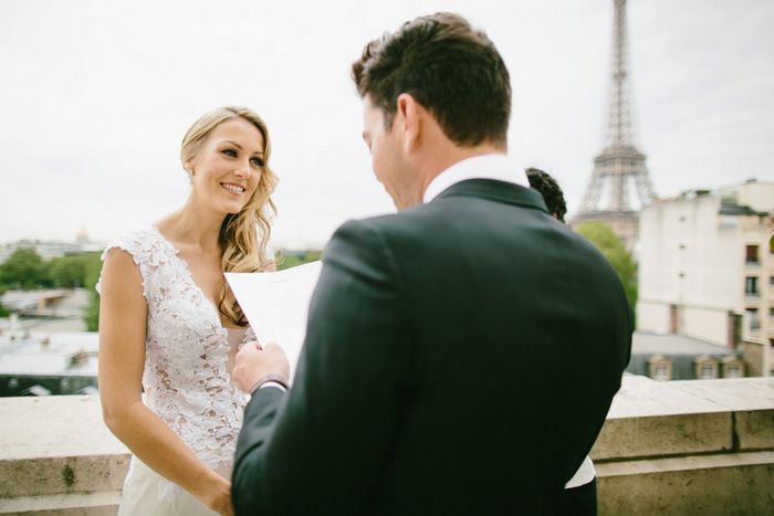 bride listening to groom read vows