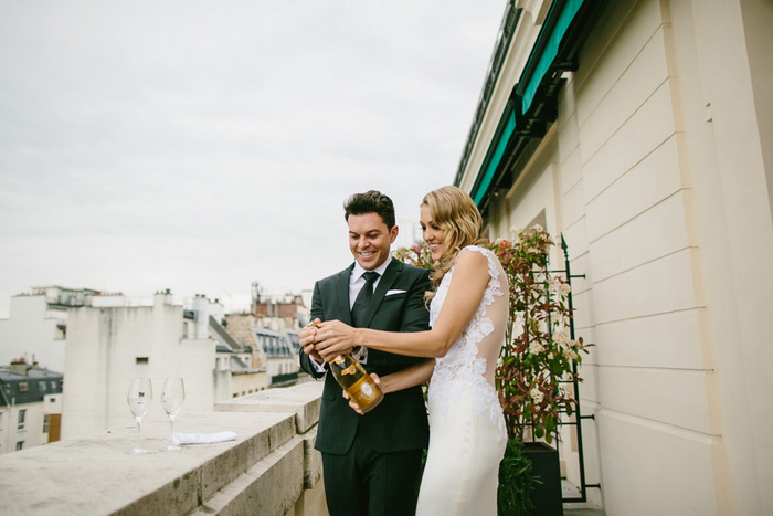 bride and groom popping champagne