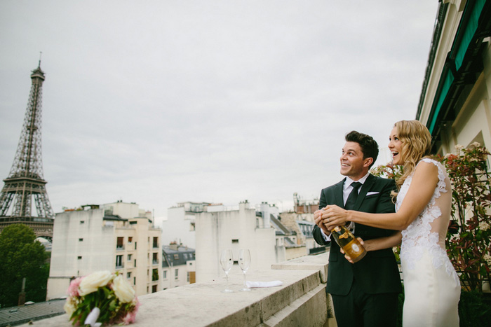 bride and groom popping champagne