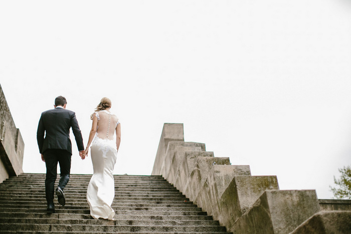 bride and groom climbing stairs in Paris