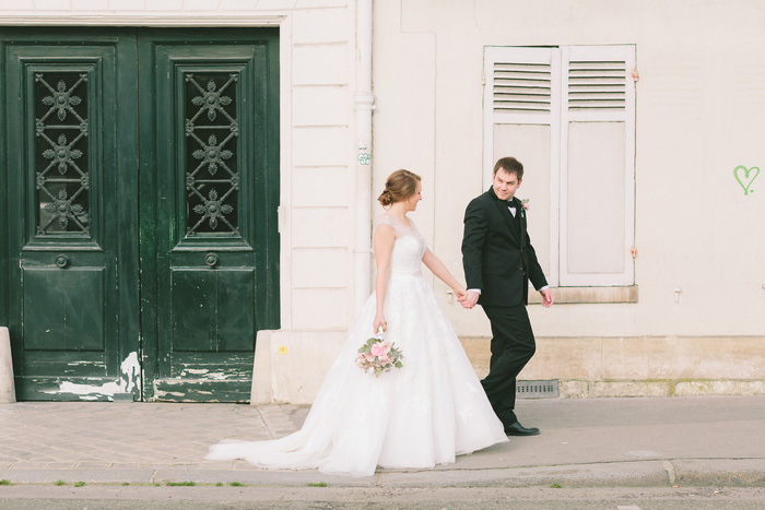 Bride and groom walking through Paris