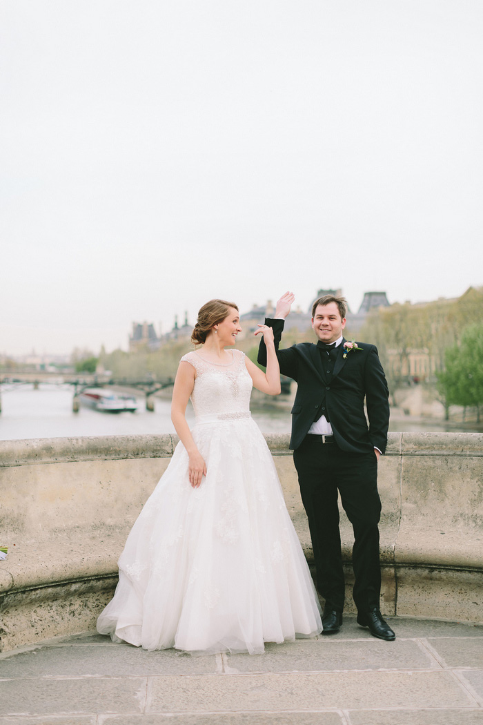 bride and groom tossing key into the seine