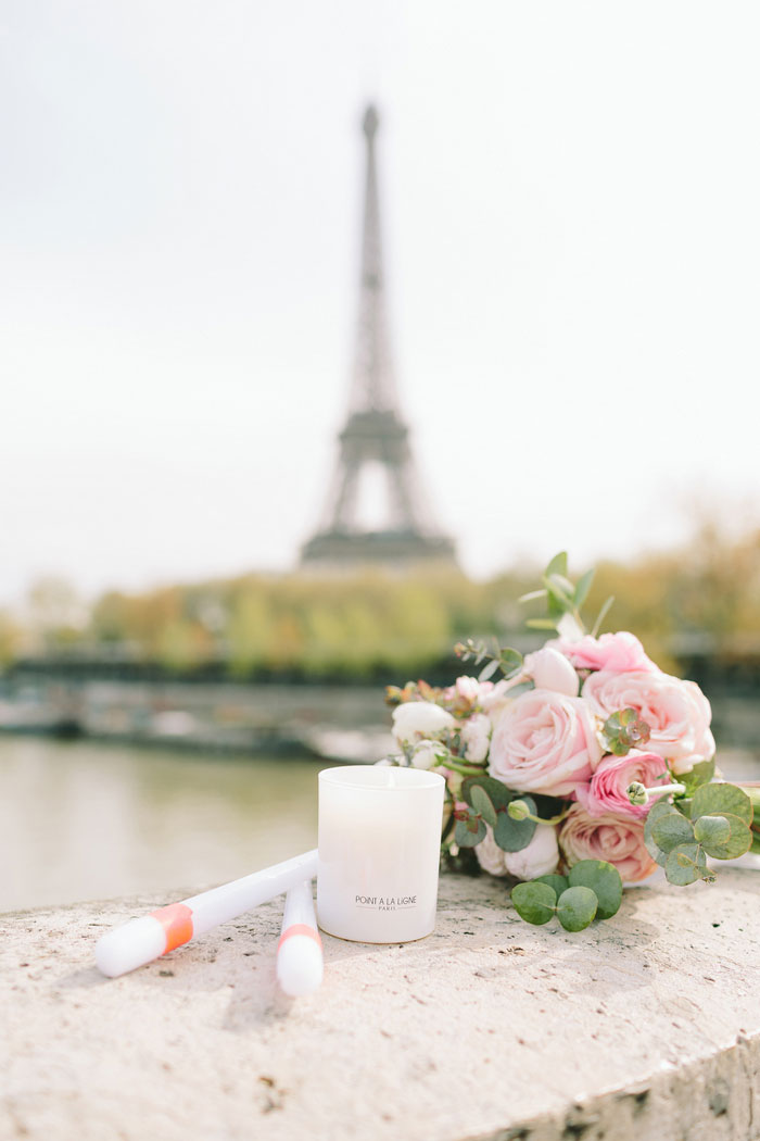 candles and bouquet with eiffel tower in the background 