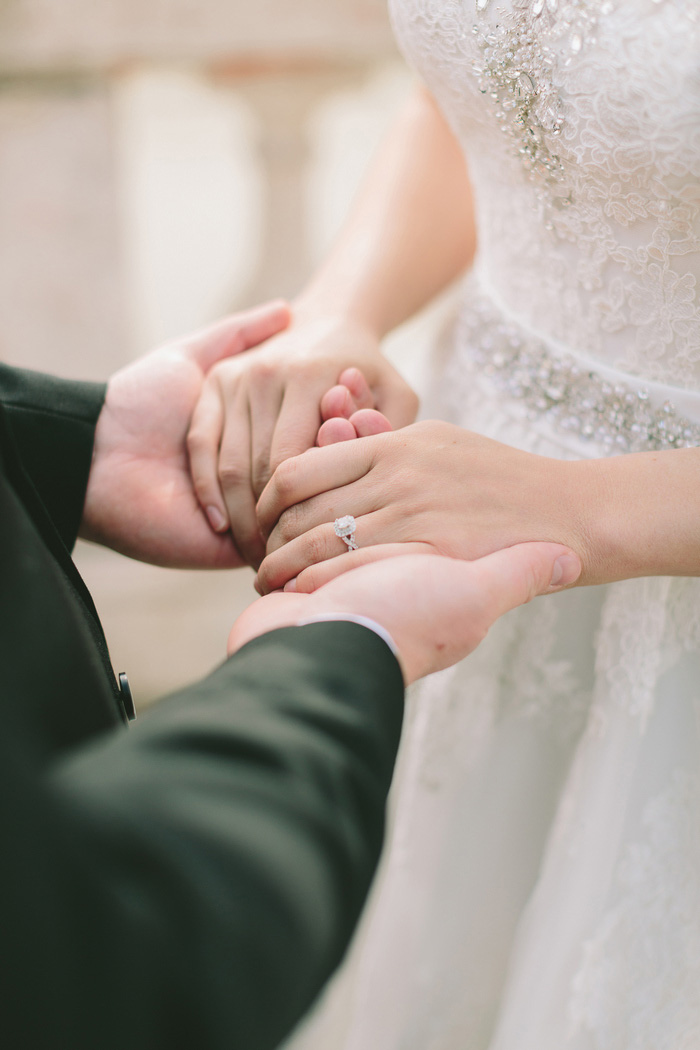 bride and groom holding hands during ceremony