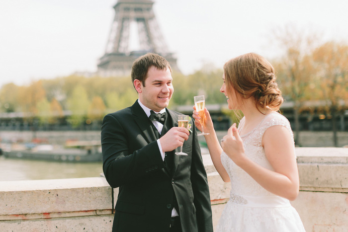 bride and groom toasting each other with champagne