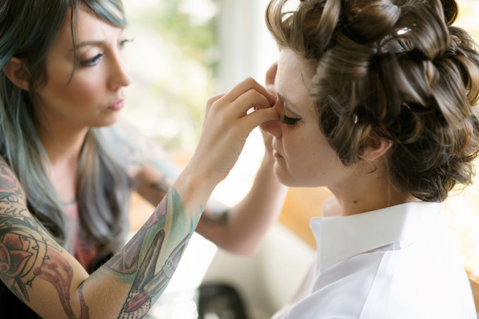 bride having fake eyelashes applied