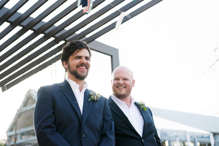 groom watching bride walk down the aisle